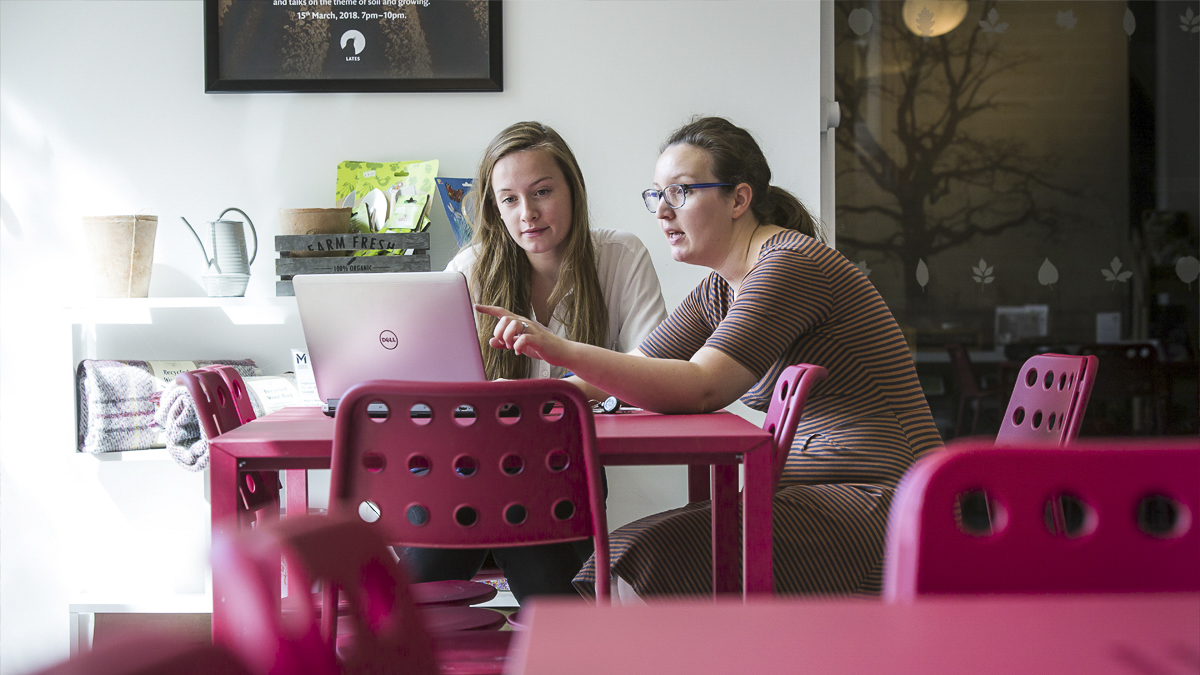 Supervisor and student discussing on a report